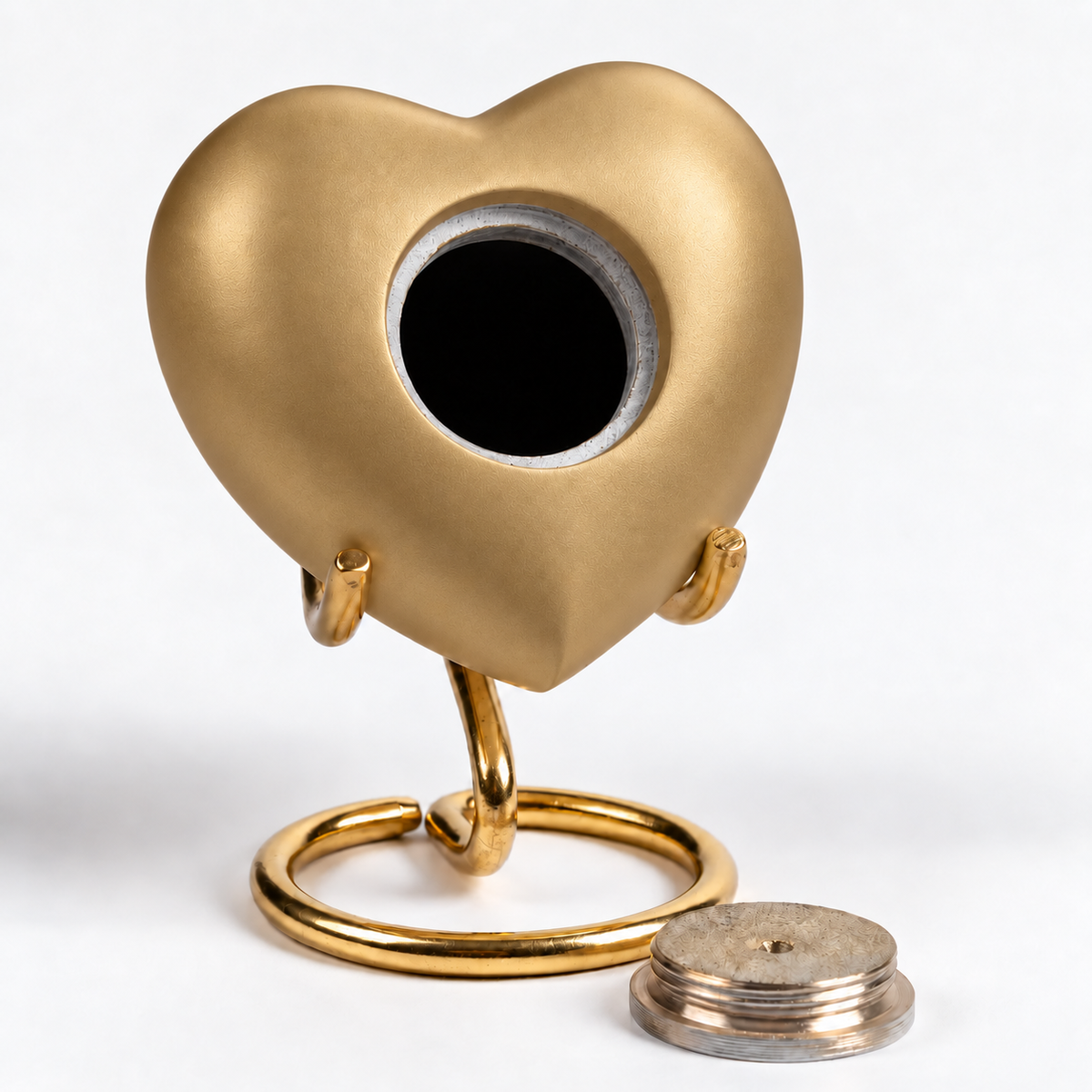 De laatste aai gouden hartvormige mini urn voor huisdieren op een standaard met losse schroefdop op witte achtergrond