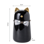 De laatste aai zwarte keramische kattenurn met gouden oren en een geruit strikje voor asbewaring.